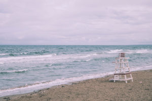 Homes for sale Lavallette NJ picture of empty beach with small waves and lifeguard stand on beach